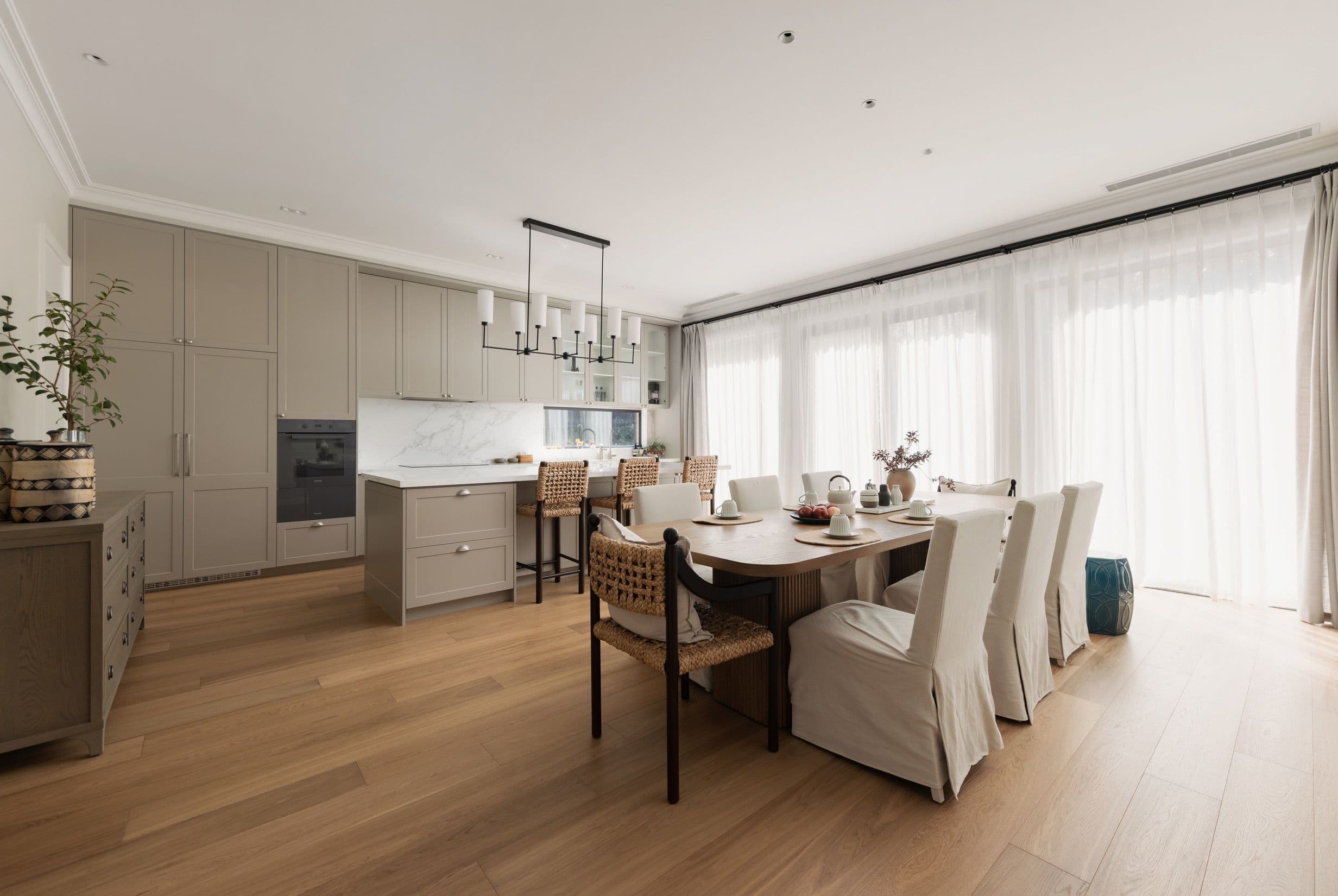 Chesterfield engineered oak flooring through an open-plan Canterbury kitchen and dining area.